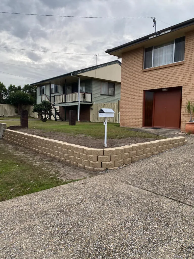Block retaining wall along a front yard driveway