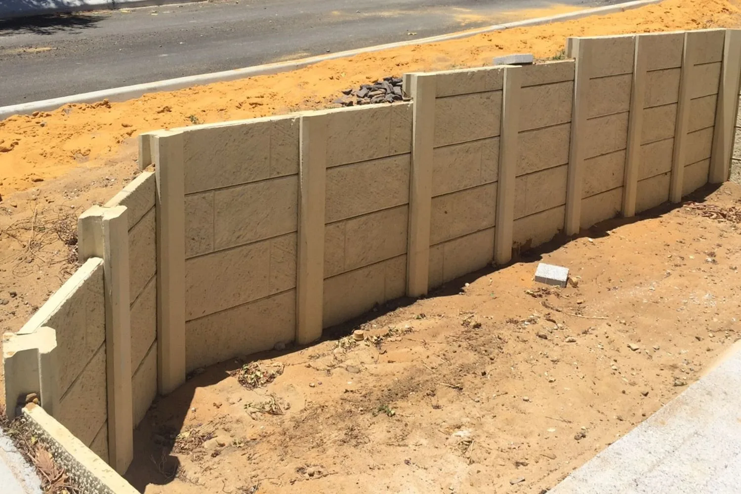 New concrete sleeper retaining wall on an excavated block