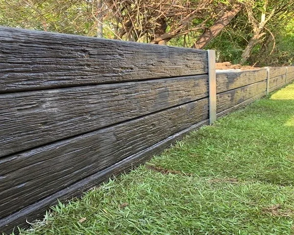 Close-up of a timber-look concrete sleeper retaining wall