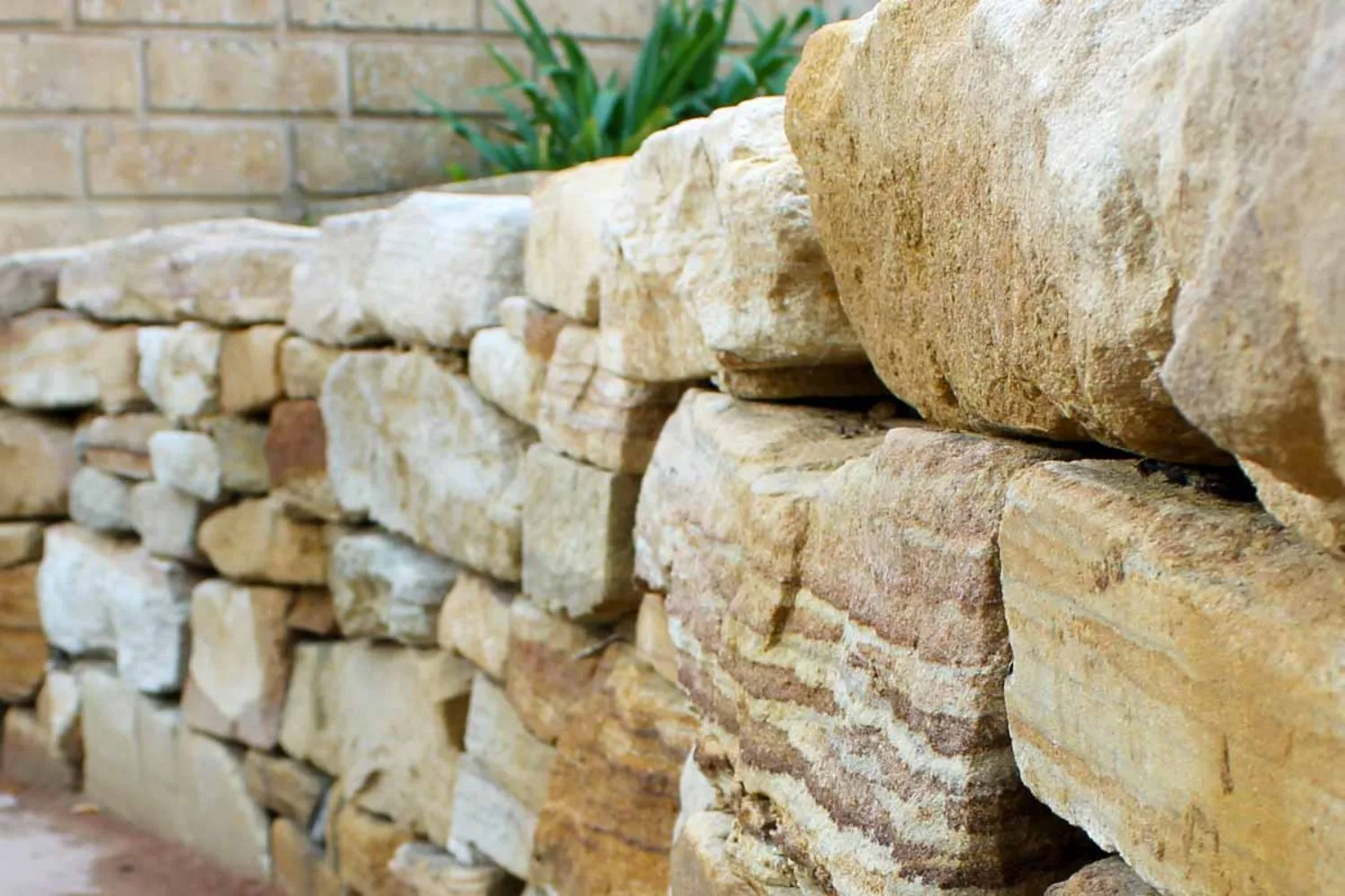 Close-up of a stacked sandstone retaining wall