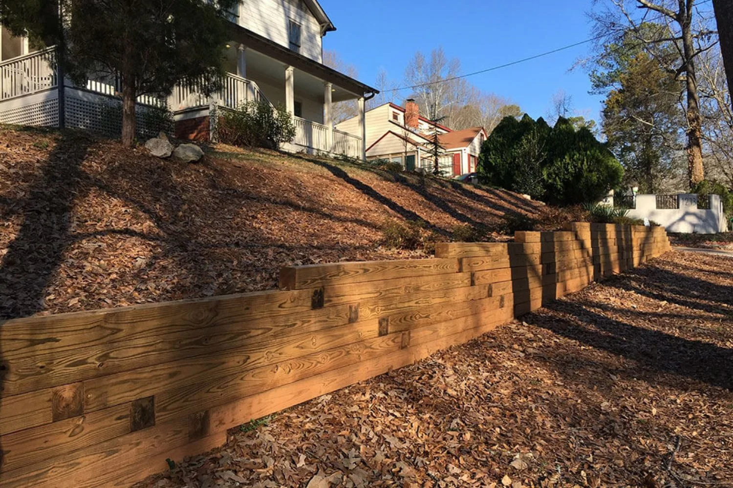 Stepped timber retaining walls on a sloping front yard